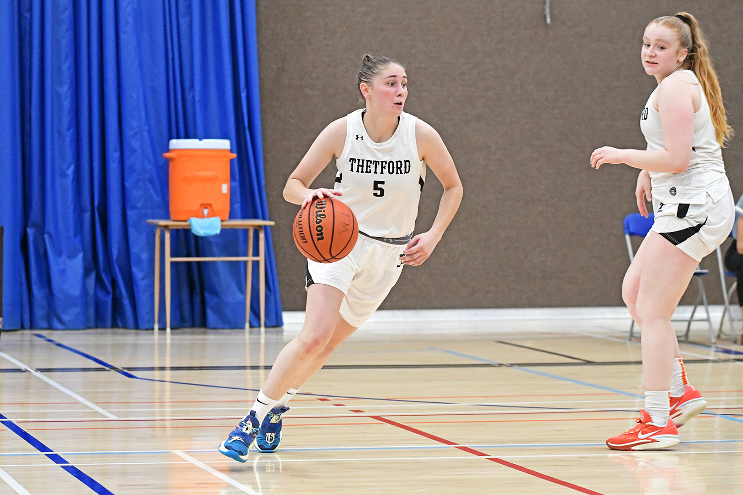 joueuse de basketball dribblant avec le ballon
